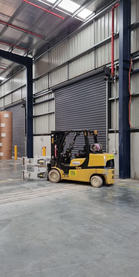 Warehouse loading bay with industrial automatic roller door motor